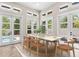 Bright dining room with light wood furniture and direct access to pool area, perfect for indoor/outdoor living at 324 Siesta Dr, Sarasota, FL 34242