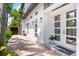 Beautiful exterior featuring modern design with decorative lamps, lush landscaping, and a brick driveway at 324 Siesta Dr, Sarasota, FL 34242