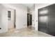 Hallway boasts travertine floors, neutral paint and modern black doors at 324 Siesta Dr, Sarasota, FL 34242