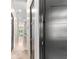 Hallway featuring sleek dark wood doors and marble-like flooring at 324 Siesta Dr, Sarasota, FL 34242
