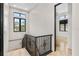 Bright hallway features sleek wrought iron railing, black trimmed windows and neutral paint at 324 Siesta Dr, Sarasota, FL 34242