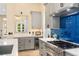 This kitchen features a stainless steel oven, gray cabinets, and a wine fridge for modern convenience at 324 Siesta Dr, Sarasota, FL 34242