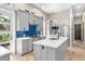 Modern kitchen with gray cabinets, quartz countertops, stainless steel appliances, and bright blue backsplash at 324 Siesta Dr, Sarasota, FL 34242