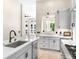 Open concept kitchen with white countertops and stainless appliances that looks into a bright living area at 324 Siesta Dr, Sarasota, FL 34242