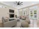 Inviting living room features a fireplace, TV, comfortable seating and a seamless connection to outdoor spaces at 324 Siesta Dr, Sarasota, FL 34242