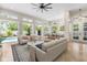 Open-concept living area with views of the backyard pool and outdoor living space through multiple French doors at 324 Siesta Dr, Sarasota, FL 34242