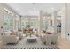Bright and spacious living room with high ceilings, neutral decor, dining area, and abundant natural light at 324 Siesta Dr, Sarasota, FL 34242