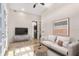 Bright living room with modern furnishings, neutral color palette, and a sleek entertainment center at 324 Siesta Dr, Sarasota, FL 34242