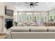 Bright living room with fireplace, comfortable seating, and doors opening to the outdoor pool area at 324 Siesta Dr, Sarasota, FL 34242