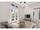 Bright staged living room features neutral paint, travertine floors and french doors to balcony at 324 Siesta Dr, Sarasota, FL 34242