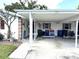 Exterior view of a well-maintained home with a large carport and unique desert landscaping at 3321 Fuller St # 105, Sarasota, FL 34231