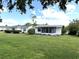 Exterior view of a home with an enclosed patio and manicured lawn, perfect for outdoor living at 3321 Fuller St # 105, Sarasota, FL 34231