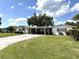 Charming single-story home featuring a covered carport and a well-manicured lawn at 3321 Fuller St # 105, Sarasota, FL 34231