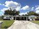 Charming single-story home featuring a covered carport and a well-maintained front lawn at 3321 Fuller St # 105, Sarasota, FL 34231