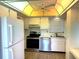 Bright kitchen featuring white cabinets, stainless steel appliances, and a unique skylight at 3321 Fuller St # 105, Sarasota, FL 34231