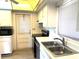 Cozy kitchen featuring white cabinets, stainless steel appliances, and a functional layout at 3321 Fuller St # 105, Sarasota, FL 34231