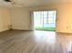 Open living area with sliding glass doors to the lanai, providing plenty of natural light at 3321 Fuller St # 105, Sarasota, FL 34231