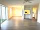 Bright, open-concept living space with modern floors and a view into the kitchen at 3321 Fuller St # 105, Sarasota, FL 34231