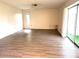 Spacious living room with modern flooring and sliding glass doors to the lanai at 3321 Fuller St # 105, Sarasota, FL 34231