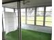 Bright sun room featuring a ceiling fan, folding screen, and outdoor views through large windows at 3321 Fuller St # 105, Sarasota, FL 34231