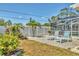 Lush backyard retreat featuring a serene seating area with lounge chairs surrounded by tropical plants at 3402 Key Ave, Sarasota, FL 34239