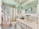 Vintage bathroom with colorful tile and fixtures, plus a shower-tub combination and vanity at 3402 Key Ave, Sarasota, FL 34239