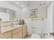 Clean bathroom with a single sink vanity, updated fixtures, and tile flooring at 3402 Key Ave, Sarasota, FL 34239