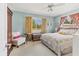 Comfortable bedroom with a ceiling fan, soft carpet, and a window overlooking the yard at 3402 Key Ave, Sarasota, FL 34239