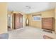 Spacious bedroom with neutral carpet and paint, featuring multiple dressers and ample closet space at 3402 Key Ave, Sarasota, FL 34239