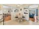 Sunlit breakfast nook featuring a round table and seating with views into the adjacent living room at 3402 Key Ave, Sarasota, FL 34239