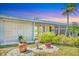 Close-up of the front exterior showcasing decorative concrete block, lush landscaping, and inviting entrance at 3402 Key Ave, Sarasota, FL 34239