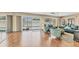 Bright living room with sliding glass doors to the pool, wood floors, and comfortable seating at 3402 Key Ave, Sarasota, FL 34239