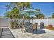Outdoor patio area featuring a dining table with umbrella, ideal for outdoor entertaining at 3402 Key Ave, Sarasota, FL 34239
