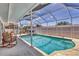 Inviting screened pool with ample seating and clear blue water, perfect for relaxation and entertainment at 3402 Key Ave, Sarasota, FL 34239