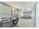 Enclosed sun room with a desk, chair, and comfortable seating area at 3402 Key Ave, Sarasota, FL 34239