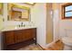 Bathroom features wood-look tile floors, wood vanity with white countertop, and a framed mirror and glass enclosed shower at 3406 67Th Street E Ct, Bradenton, FL 34208