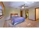 Bedroom features neutral walls and carpet, two windows with blinds, and ceiling fan at 3406 67Th Street E Ct, Bradenton, FL 34208