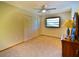 Bedroom featuring a closet, bureau, and large window with a bicycle accent piece in a bright space at 3406 67Th Street E Ct, Bradenton, FL 34208