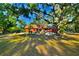 Charming single-story home with a rustic feel, surrounded by mature trees and lush landscaping on a spacious lot at 3406 67Th Street E Ct, Bradenton, FL 34208
