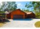 Charming single-Gathering home featuring a gravel driveway, an attached garage, and lush, mature trees at 3406 67Th Street E Ct, Bradenton, FL 34208