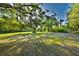 Expansive green yard with shade trees, offering privacy and a natural setting for the property at 3406 67Th Street E Ct, Bradenton, FL 34208