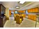 Spacious kitchen with tile floors, wood cabinets, stainless appliances, and multiple dining areas for Gathering meals at 3406 67Th Street E Ct, Bradenton, FL 34208