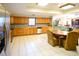 Bright kitchen features wood cabinets, tile floors, stainless appliances and offers ample space for cooking and dining at 3406 67Th Street E Ct, Bradenton, FL 34208