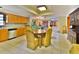 Functional kitchen featuring wood cabinets, tile floors, stainless steel appliances and a cozy dining area at 3406 67Th Street E Ct, Bradenton, FL 34208