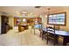 Eat-in kitchen featuring tile floors, wood cabinetry, stainless steel appliances, and casual dining areas at 3406 67Th Street E Ct, Bradenton, FL 34208
