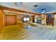 Open-concept living room boasts a brick fireplace, wood-look floors, wood paneling, and ample seating at 3406 67Th Street E Ct, Bradenton, FL 34208