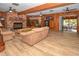 Spacious living room with wood-look floors, a brick fireplace, wood beams and access to the outside lanai at 3406 67Th Street E Ct, Bradenton, FL 34208