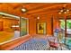Enclosed porch with wood ceiling and accents features sliding glass doors and a dining table at 3406 67Th Street E Ct, Bradenton, FL 34208