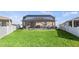 Large backyard with lush green lawn and screened-in patio, offering a peaceful outdoor living space at 3478 74Th Avenue E Cir, Sarasota, FL 34243