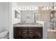 A bathroom with a double vanity, granite countertop, and glass shower at 3478 74Th Avenue E Cir, Sarasota, FL 34243